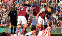 West Ham United's Winston Reid challenges Stoke City's Peter Crouch after a foul by Peter Crouch on Matthew Taylorduring the Barclays Premier League match at the Britannia Stadium, Stoke.