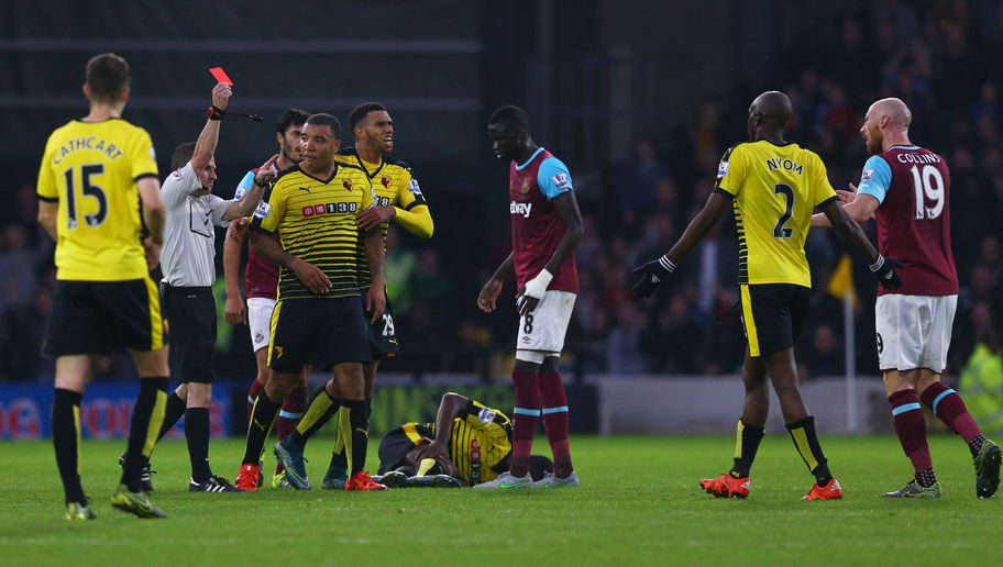 WATFORD, ENGLAND - OCTOBER 31:  James Collins (1st R) of West Ham United is shown a red card by referee Keith Stroud (2nd L) during the Barclays Premier League match between Watford and West Ham United at Vicarage Road on October 31, 2015 in Watford, England.  (Photo by Harry Engels/Getty Images)